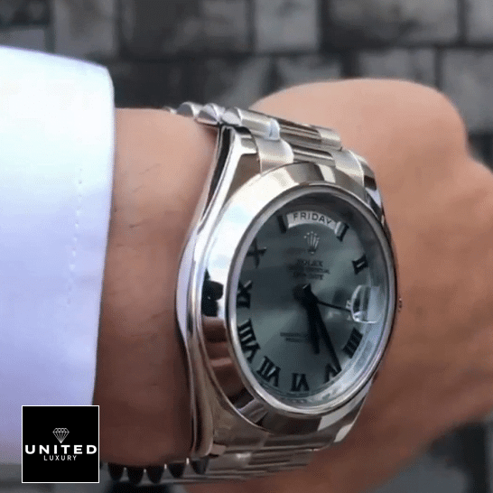 Rolex Day-Date 228206 the man has a Rolex Day-Date II Stainless Steel Ice Blue Roman Dial 218206 Replica