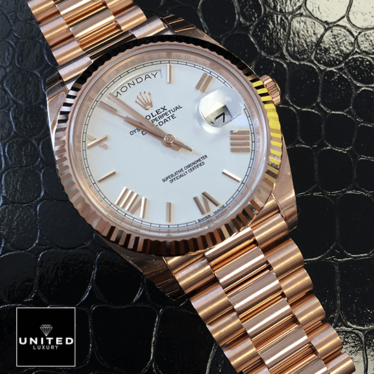 Rolex Day-Date 228235 Rolex Day-Date 228235 Rose Gold Replica on the black leather table