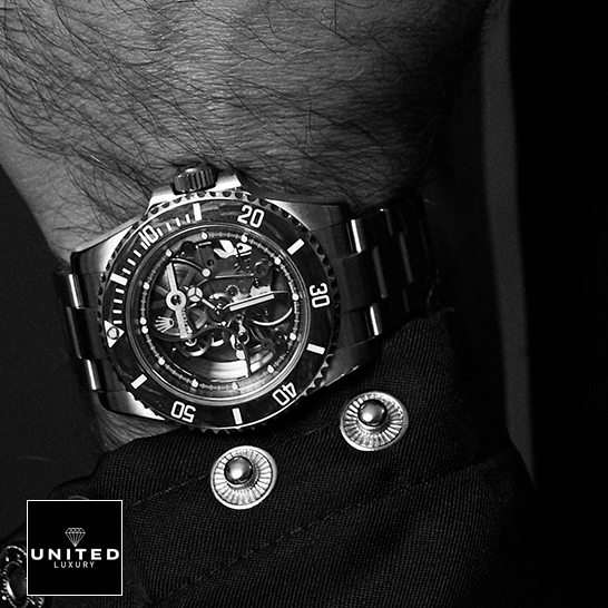 Rolex Submariner 114200 Rolex Oyster Perpetual Skeleton Replica on a man's wrist