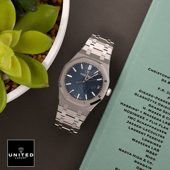 Audemars Piguet Royal Oak 15500ST Audemars Piguet Royal Blue Dial Steel Bezel Replica next to flowers