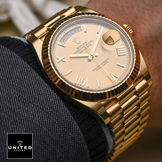 Rolex Day-Date 228238-0007 Rolex Day-Date II 228238-0007 Yellow Gold Romen Numerial Dial Replica on is arm